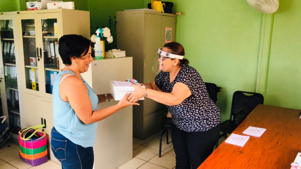 Women sharing Mother's Day gift boxes in Bijagua, Costa Rica